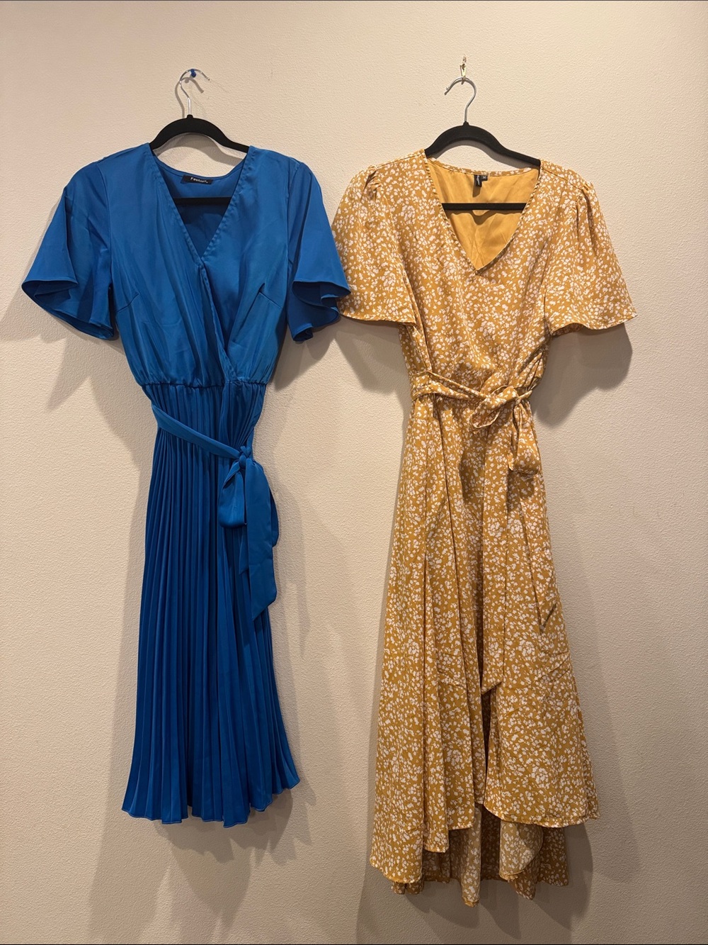 Two dresses- blue pleated with belt and yellow floral with belt